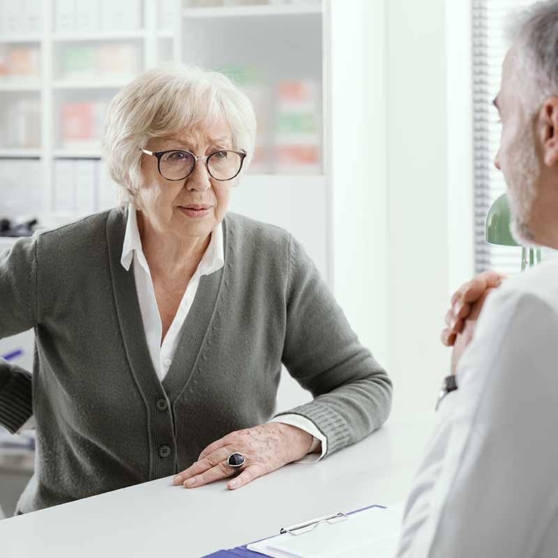elderly patient talking to doctor